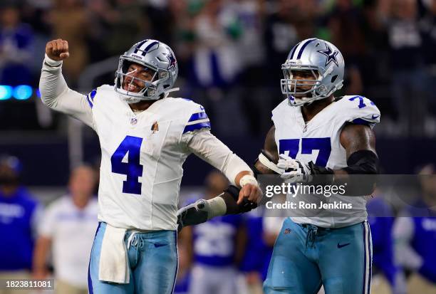 Quarterback Dak Prescott of the Dallas Cowboys celebrates with offensive tackle Tyron Smith after throwing for a touchdown during the 4th quarter of...