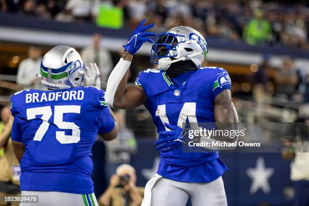 Metcalf of the Seattle Seahawks celebrates with Anthony Bradford of the Seattle Seahawks after completing a pass for a touchdown during an NFL...