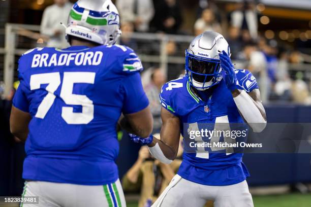 Metcalf of the Seattle Seahawks celebrates with Anthony Bradford of the Seattle Seahawks after completing a pass for a touchdown during an NFL...