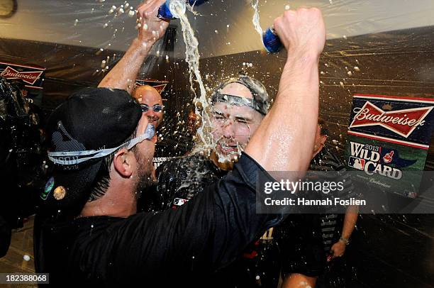 Yan Gomes and Justin Masterson of the Cleveland Indians celebrate with champagne after a win of the game against the Minnesota Twins on September 29,...