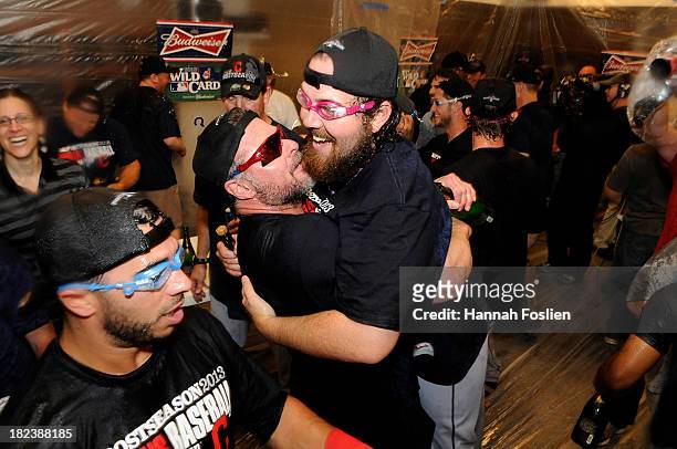 Mike Aviles, Jason Giambi and Chris Perez of the Cleveland Indians celebrate with champagne after a win of the game against the Minnesota Twins on...