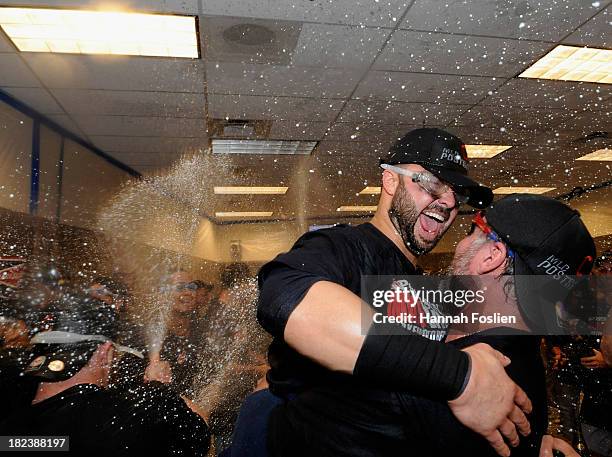 Nick Swisher and Jason Giambi of the Cleveland Indians celebrate with champagne after a win of the game against the Minnesota Twins on September 29,...
