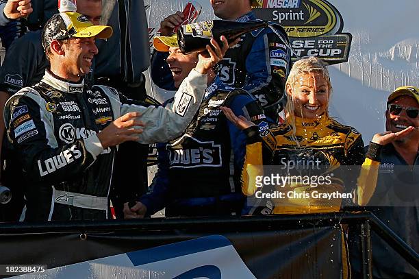 Chad Knaus, crew chief of the Lowe's / Kobalt Tools Chevrolet, douses Miss Sprint Brooke Werner with champagne in Victory Lane after winning the...