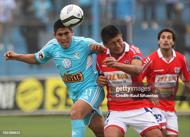 Irven Avila of Sporting Cristal fights for the ball with Nixon Villoslada of Union Comercio during a match between Sporting Cristal and Union...