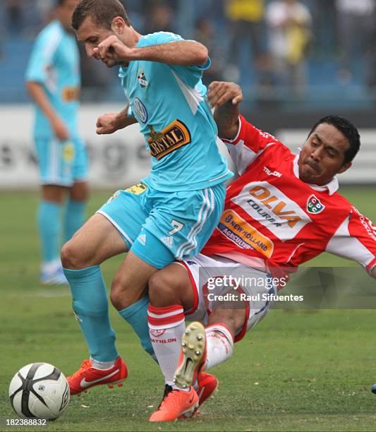 Horacio Calcaterra of Sporting Cristal fights for the ball with Jose Corcuera of Union Comercio during a match between Sporting Cristal and Union...