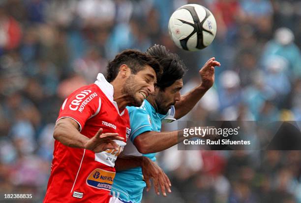 Jorge Cazulo of Sporting Cristal fights for the ball with Juan Cominges of Union Comercio during a match between Sporting Cristal and Union Comercio...