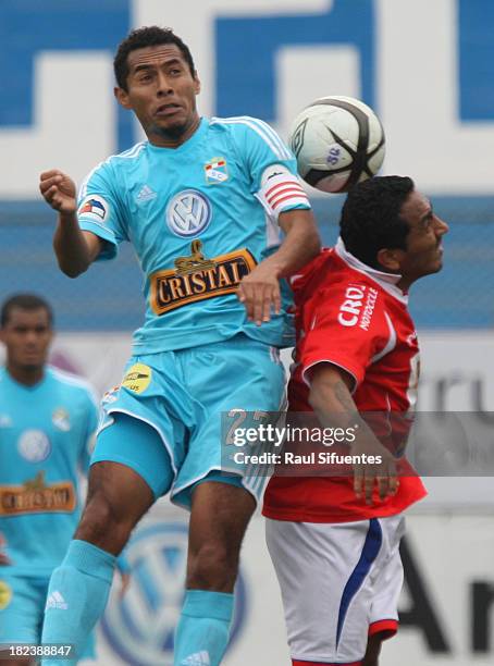 Carlos Lobaton of Sporting Cristal fights for the ball with Jose Corcuera of Union Comercio during a match between Sporting Cristal and Union...