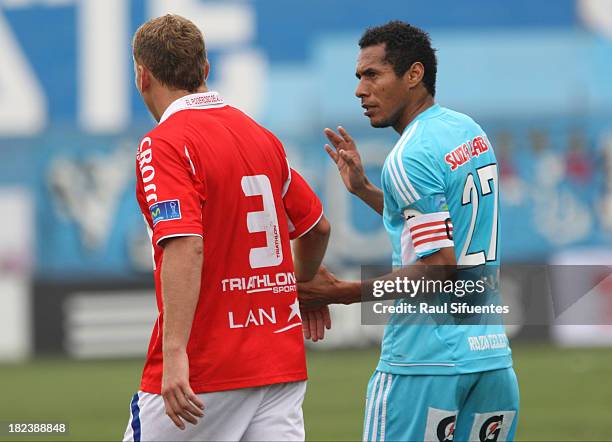 Carlos Lobaton of Sporting Cristal talks to Joaquin Lencinas of Union Comercio during a match between Sporting Cristal and Union Comercio as part of...