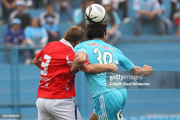 Jose Carlos Fernadez of Sporting Cristal fights for the ball with Joaquin Lencinas of Union Comercio during a match between Sporting Cristal and...