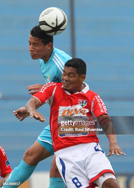 Marcos Delgado of Sporting Cristal fights for the ball with Wilder Huaynacari of Union Comercio during a match between Sporting Cristal and Union...