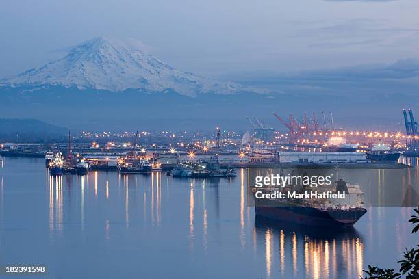a photo of port tacoma and a snow topped mount rainier - washington state stock pictures, royalty-free photos & images
