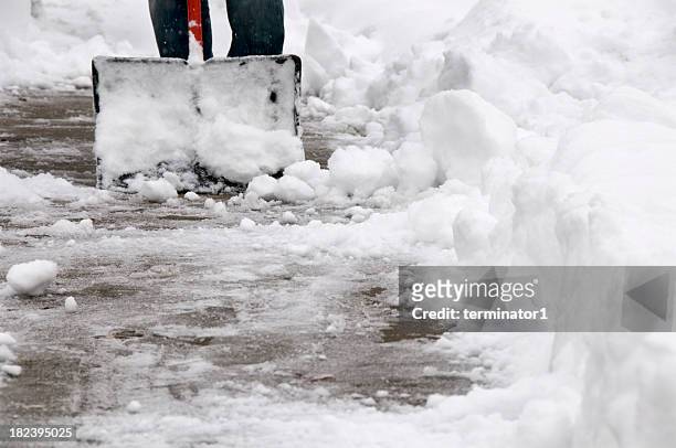 shoveling snow from sidewalk - removal men stockfoto's en -beelden