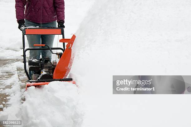 woman operating snowblower - sneeuwmachine stockfoto's en -beelden
