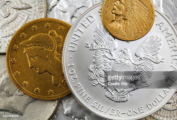 silver and gold coins - gold coin stockfoto's en -beelden