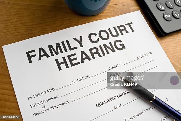 family court hearing document on a desktop - in law relations stockfoto's en -beelden