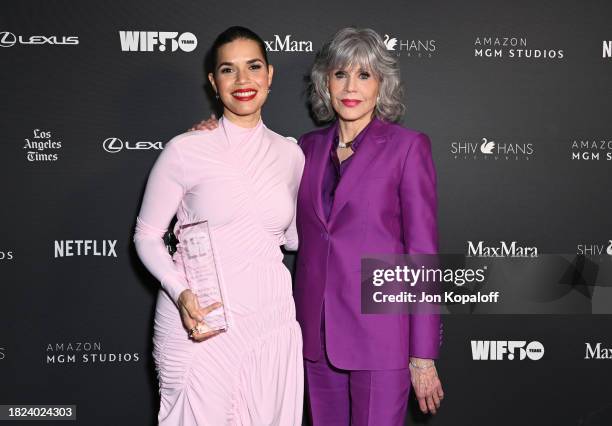 Winner of the Jane Fonda Humanitarian Award America Ferrera, wearing Sportmax and Jane Fonda, wearing Max Mara, pose backstage during WIF Honors...