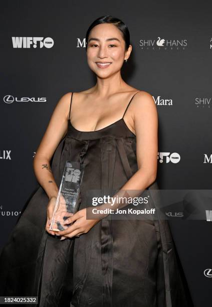 Winner of the Crystal Award for Advocacy Greta Lee, wearing Max Mara, poses backstage during WIF Honors Presented by Max Mara on November 30, 2023 in...