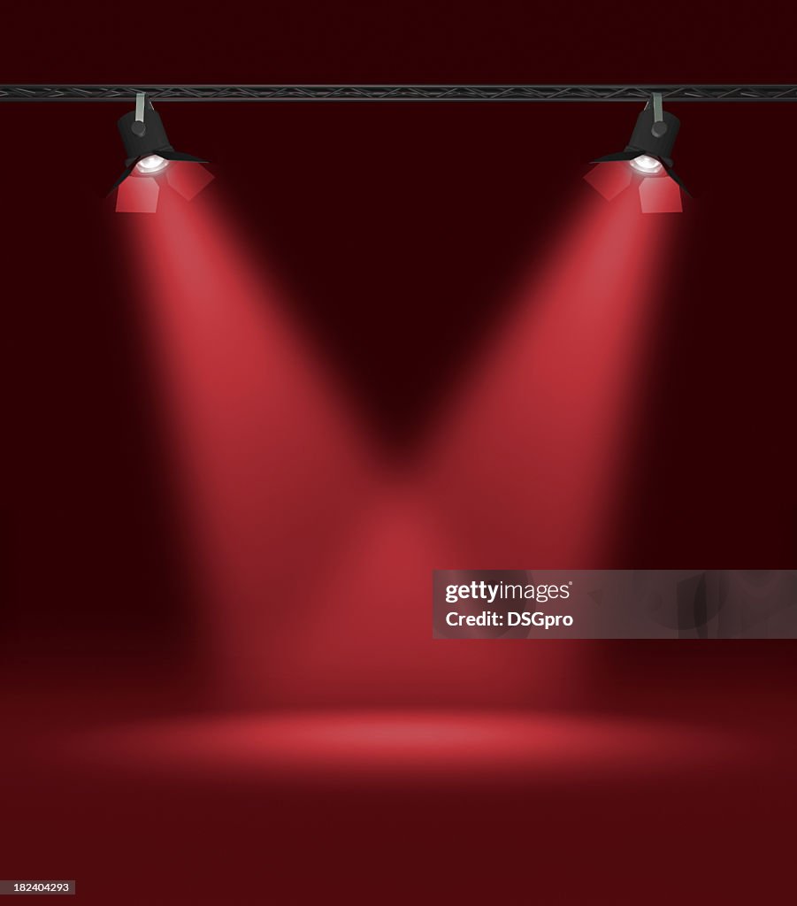 Two red spotlights shedding light on a black background