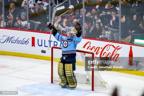 Goaltender Laurent Brossoit of the Winnipeg Jets celebrates following a 2-1 victory over the Carolina Hurricanes at the Canada Life Centre on...