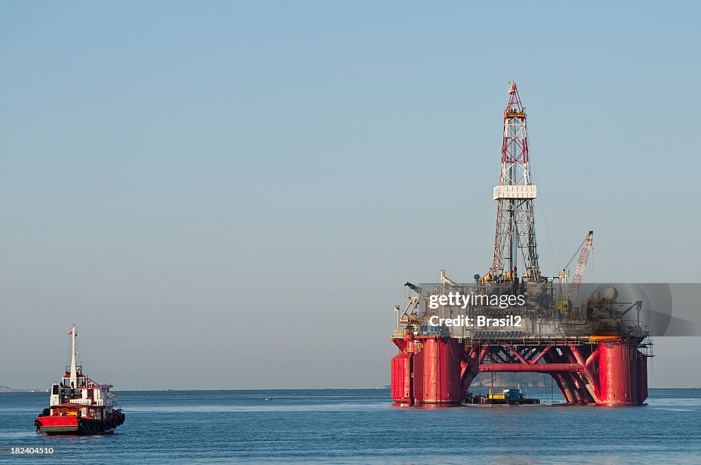 A gigantic oil rig platform and boat