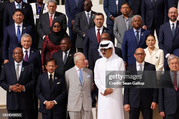 King Charles III speaks with Qatari Emir Sheikh Tamim bin Hamad Al Thani as they join fellow heads of state for a group photo during day one of the...