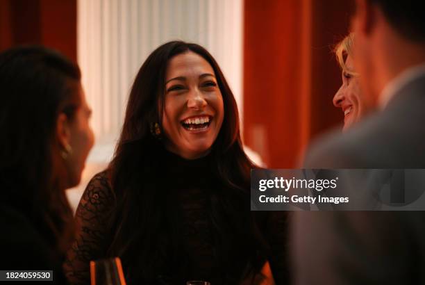 Christen Press, Grassroot Soccer Global Ambassador, laughs with other guests at the Grassroot Soccer World AIDS Day Gala at Lindley Hall on November...