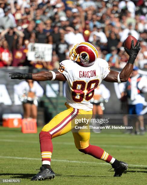 Pierre Garcon of the Washington Redskins slams the ball down after he caught a five yard touchdown pass during the third quarter against the Oakland...