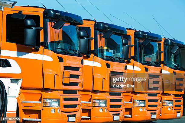 row of orange semi trucks - convoy bildbanksfoton och bilder