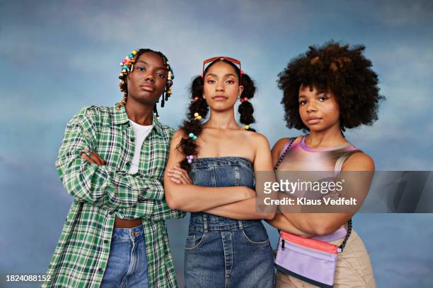 portrait of confident multiracial female friends with arms crossed standing against colored background - plaid shirt isolated stock pictures, royalty-free photos & images