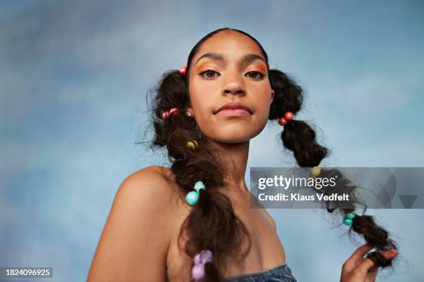 portrait of teenage girl with braided hair against colored background - attitude stock pictures, royalty-free photos & images