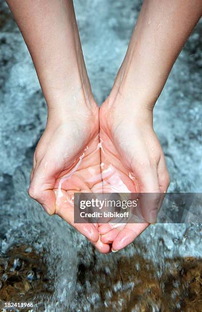 hands with pure water - spring flowing water stock pictures, royalty-free photos & images