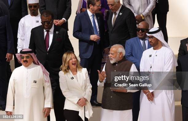 Italian Prime Minister Giorgia Meloni and Indian Prime Minister Narendra Modi share a laugh prior to a family photo of heads of state during day one...