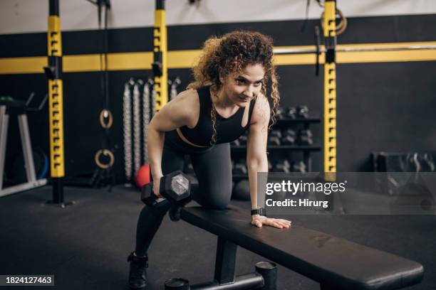 woman exercising with dumbbell - workout bench stock pictures, royalty-free photos & images