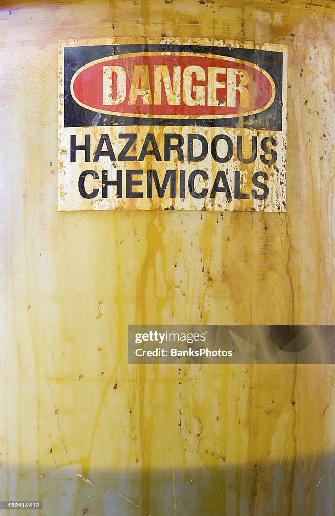 Danger Hazardous Chemicals Sign on a Translucent Barrel with Liquid