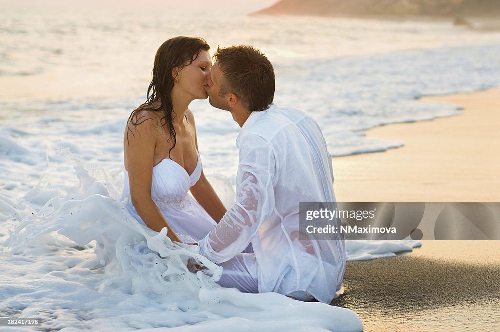 Bride and groom kissing on the beautiful beach