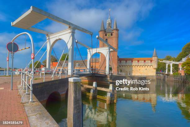 drawbridge and the city gate of the old harbor in zierikzee in zeeland - zeeland stock pictures, royalty-free photos & images