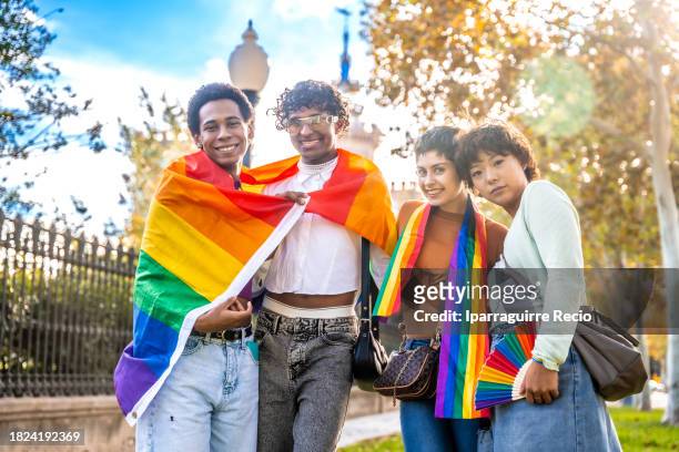 multiethnic diversity lgbt group with rainbow flag. multiracial friends having fun and proud of their identity. homosexual, lesbian, bisexual, non-binary concept - choice music group stock pictures, royalty-free photos & images