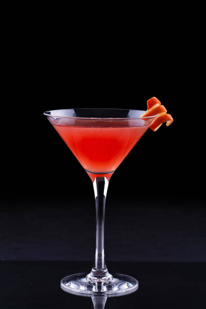 front view of cosmopolitan cocktail - orange cocktail stock pictures, royalty-free photos & images