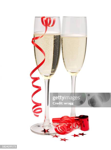 two champagne glasses with party streamers - party poppers stock pictures, royalty-free photos & images