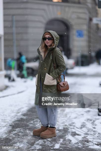 Sonia Lyson seen wearing Gucci black sunglasses, & Other Stories brown wool knit beanie, brown wool turtleneck sweater, H&M light grey cotton jogger...