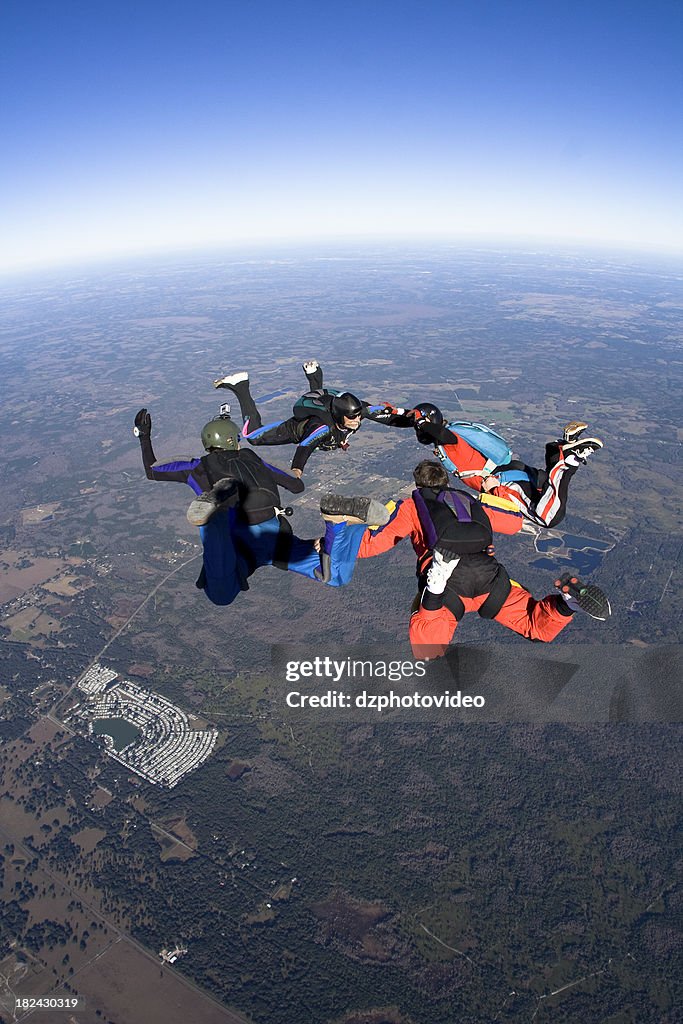 Royalty Free Stock Photo: Four Skydivers in Freefall Formation