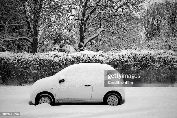 small covered  in snow parked on the street - parked car stock pictures, royalty-free photos & images