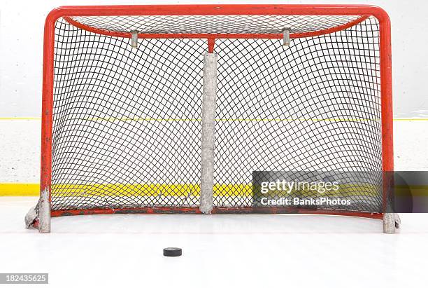 hockey puck near goal net - hockey puck in net stock pictures, royalty-free photos & images