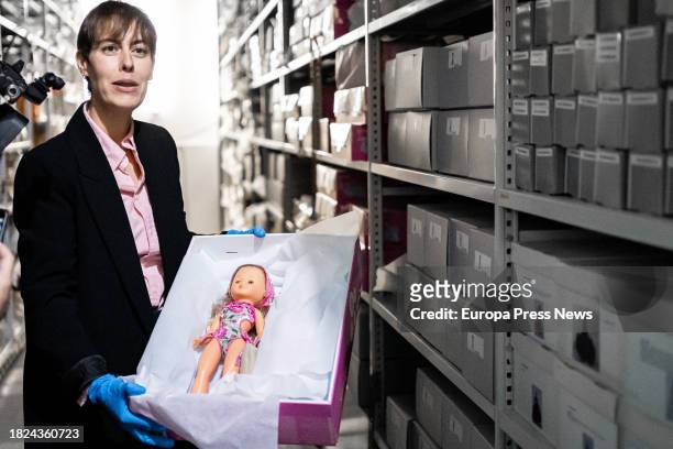 The curator of the exhibition, Ana Garcia, shows one of the dolls during the opening of an exhibition on the Nancy doll, at the Museo del Traje, on...