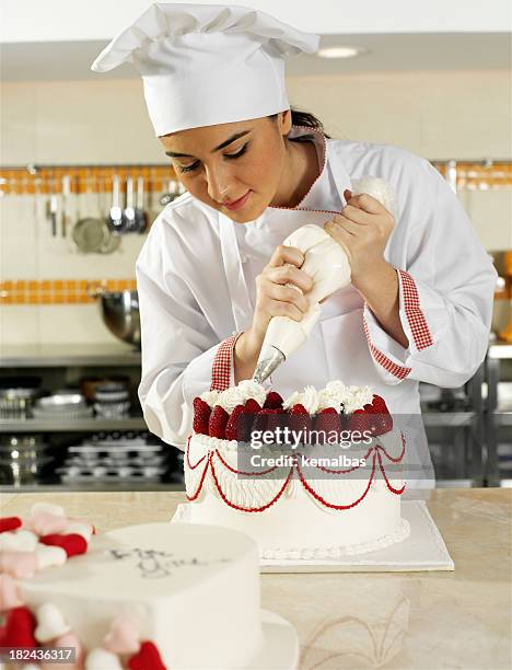 chef piping cream - finishing cake stock pictures, royalty-free photos & images