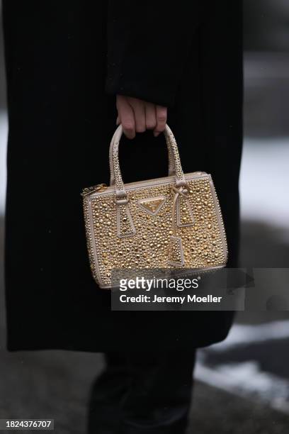 Sonia Lyson seen wearing Cos black fake fur long coat, Prada gold studded glitter bag and Cos black leather high overknees / boots, on November 29,...