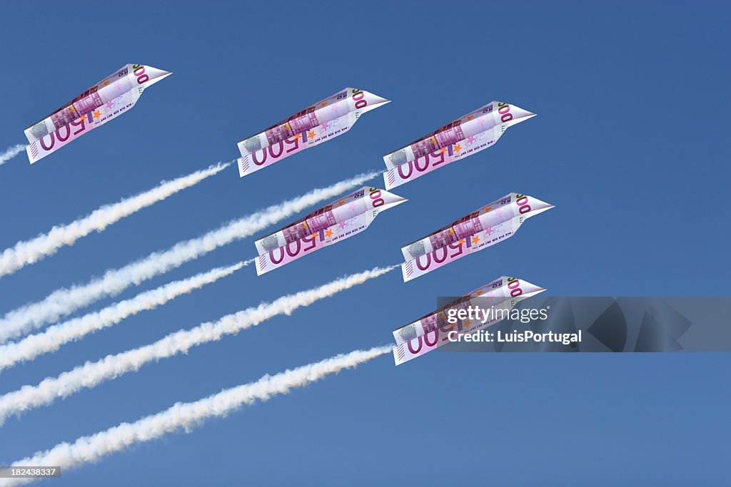 Euros folded into airplanes flying across the sky