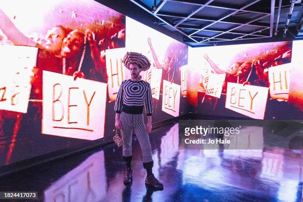 Bbence Borbely, designer & Bey Fan poses in front of Video Screens at the Beyoncé Exclusive Renaissance Flagship Store on December 1, 2023 in London,...
