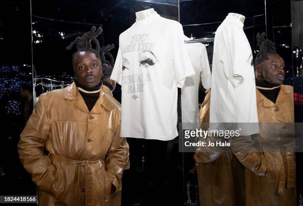 Bey Fan Ramario Chevoy poses with T Shirts at the Beyoncé Exclusive Renaissance Flagship Store on December 1, 2023 in London, England.