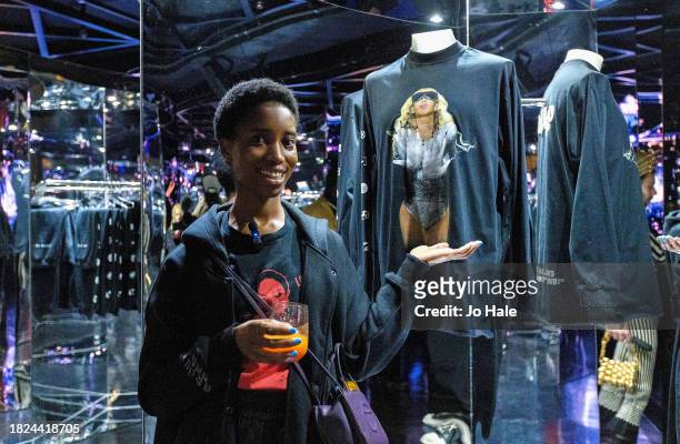 Alisha Dinah poses with Beyonce T Shirts at the Beyoncé Exclusive Renaissance Flagship Store on December 1, 2023 in London, England.